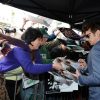 James Franco signing memorabilia for a fan.